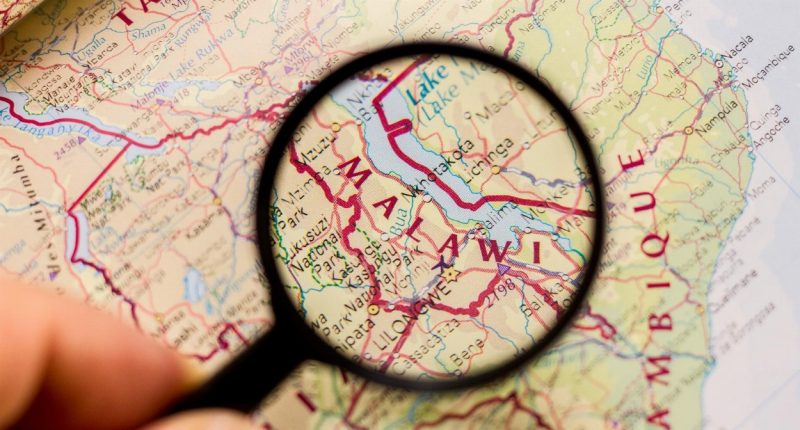 Map of Malawi being looked at through a magnifying glass.