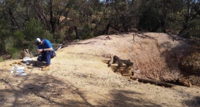 Geologist sampling dump material of the main extraction shaft estimated to be 80 metres in depth.