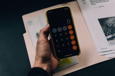 An individual uses the calculator app on their mobile device. (Source: Unsplash)