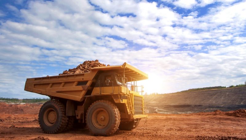 A dump truck loaded with iron ore.