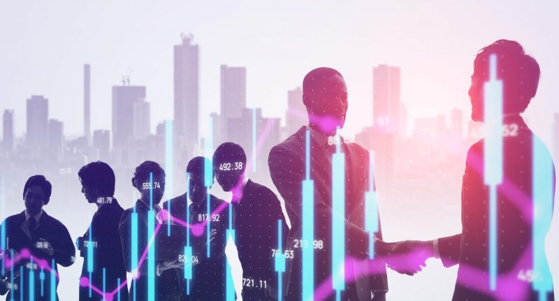 Image of business people shaking hands against a backdrop of skyscrapers.