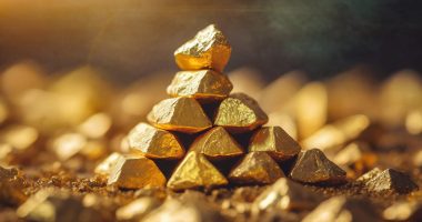 Stacked gold nuggets, golden space, close-up
