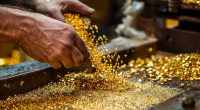 Image of man pouring out gold chips.