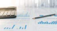 Pencil, calculator with financial chart and graph report on table of business consultant. Concept of invest planning, analyze return on investment.