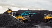 Caterpillar tractors collect black coal pile. Illustration of supply field of power station.