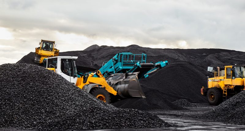 Caterpillar tractors collect black coal pile. Illustration of supply field of power station.