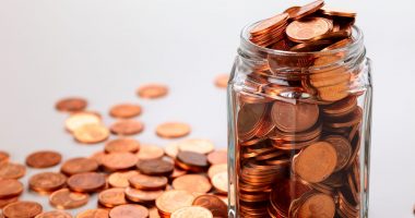 Euro cent coins in a small jar, studio shot