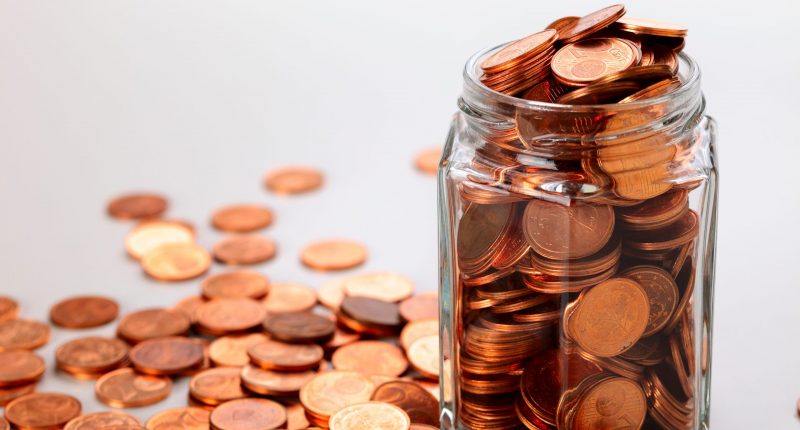 Euro cent coins in a small jar, studio shot