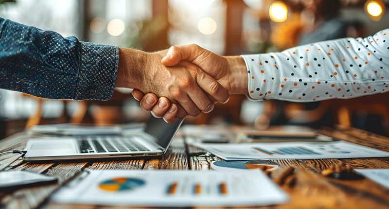 Photograph of two individuals shaking hands.