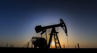 Image of an oil well at dusk.