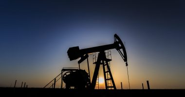 Image of an oil well at dusk.