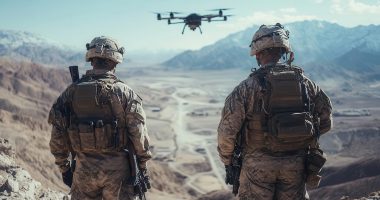 Image of two soldiers looking at a drone