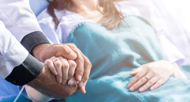 A doctor helping a patient in a hospital