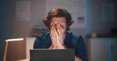 Man frustrated before laptop