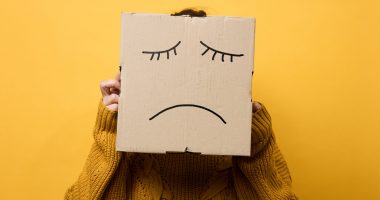 A woman with a sign and a sad face