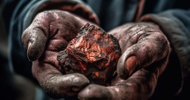 A man with a copper nugget in his hands