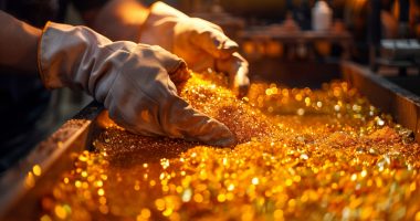 Closeup of gloves holding gold