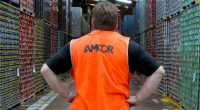 An Amcor worker looks at rows of packaging materials.