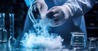 A scientist's hands work on a freezing test glass.