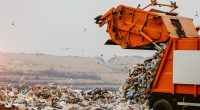 A rubbish truck dumping landfill