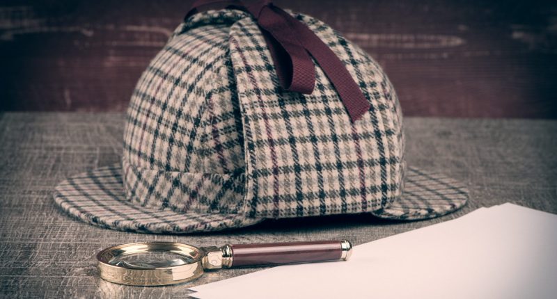 Image of a deerstalker hat and magnifying glass