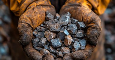 Image of a miner holding rare earth elements