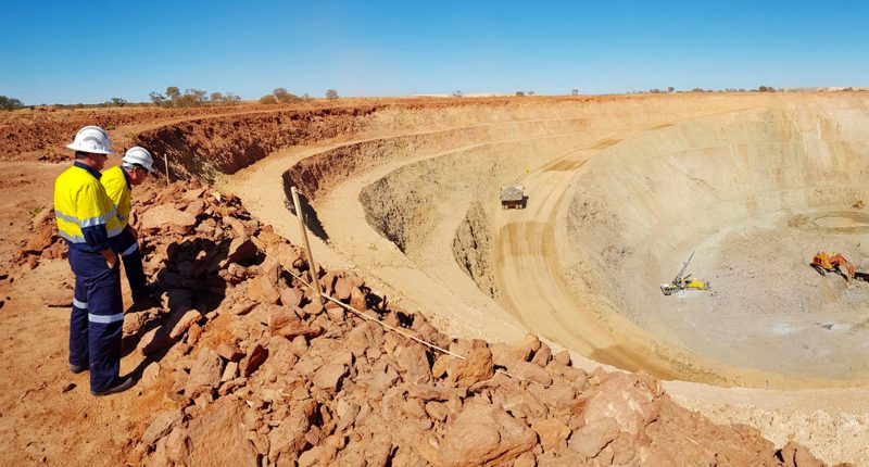 The Catalyst Metals Trident gold mine with several workers looking into a working pit.