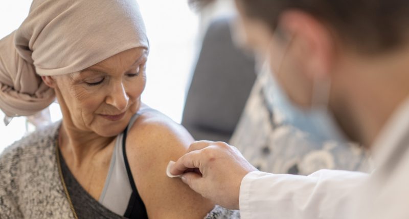 A patient being dosed with Imugene Limited testing materials.