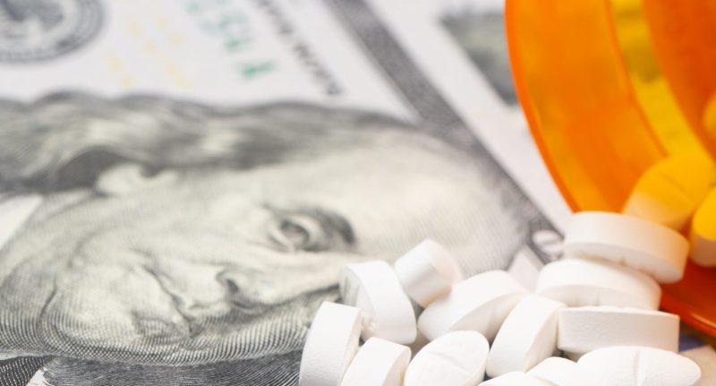 Pills on a hundred dollar bill