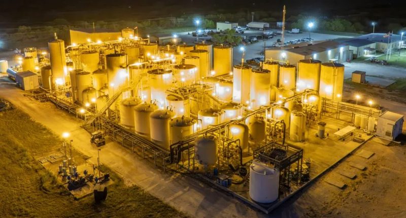 The Alta Mesa uranium project run by enCore and Boss Energy in Texas lit up yellow at night.