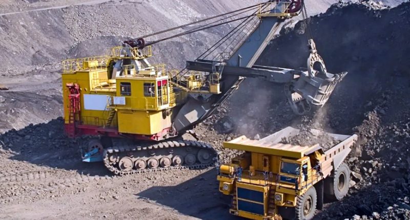 Two yellow construction trucks at the Nyanazaga Gold Project