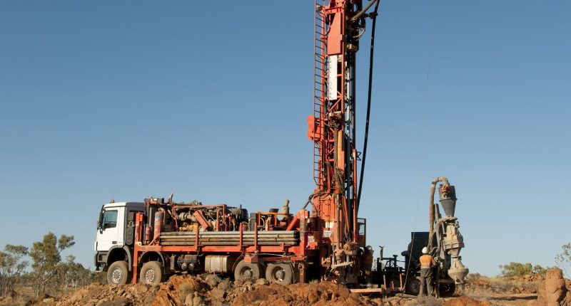 A mining truck with a long construction haul at the back