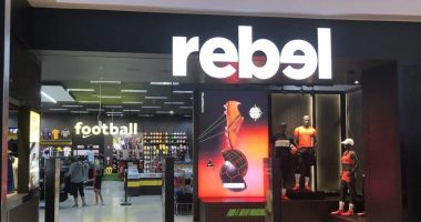 A Rebel storefront with clothes in the window.