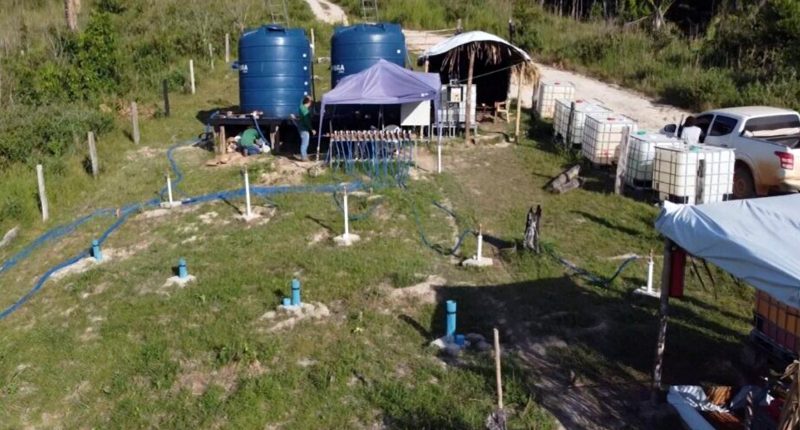 A camp site with several water tanks and a parked truck at BCN's Ema Project.