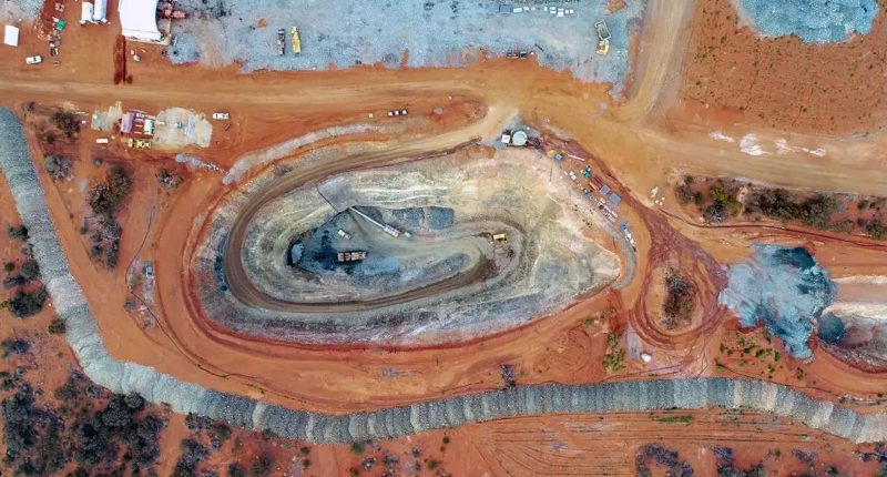 Gorilla Gold's Comet Vale digging site as seen by above. There's a mine pit in the centre, with roads and trucks on the edges of the image.
