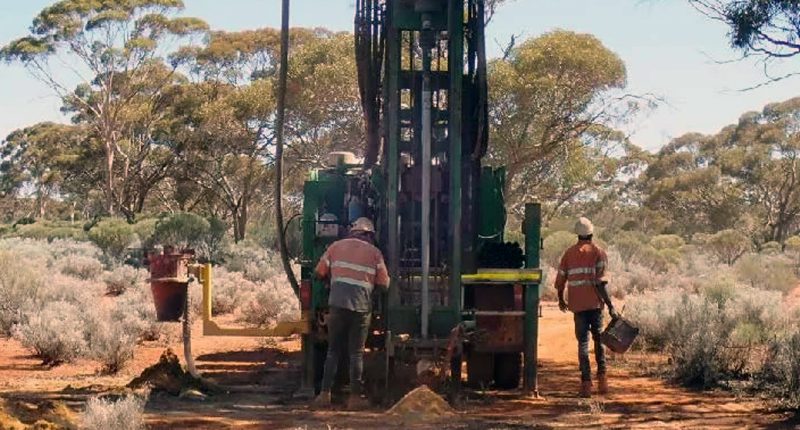 Several Miramar Resources workers in high-vis safety gear working on an exploration rig.