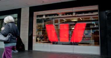 Aged woman walks in front of Westpac bank in Melbourne Australia