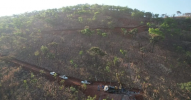 Rigs driving up a mountain road at the Step Aside lithium project.