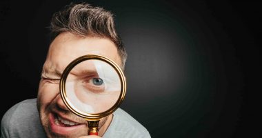 Man spies through glass in a bid to figure out what's going on