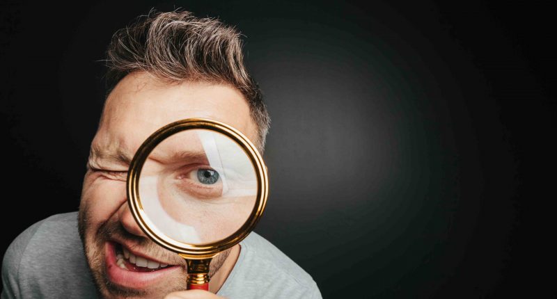 Man spies through glass in a bid to figure out what's going on