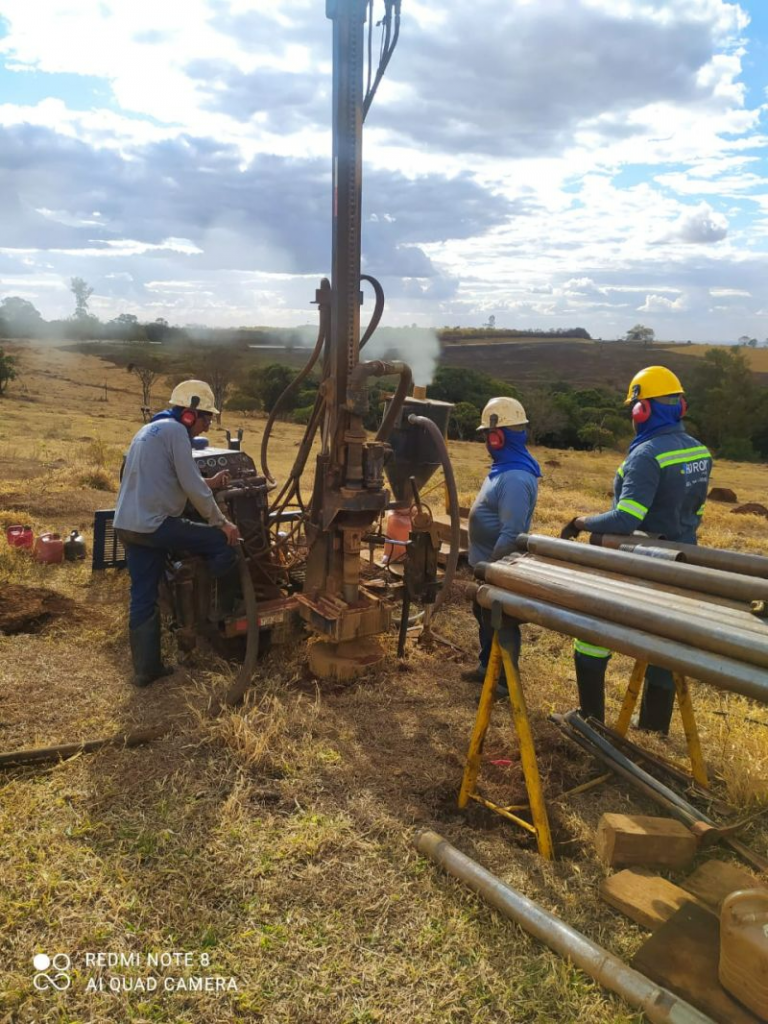 St George Mining workers next to drilling gear