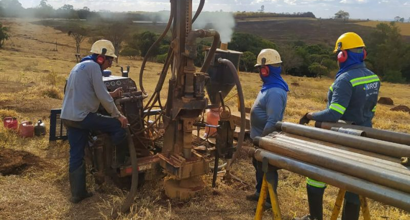 St George Mining workers next to drilling gear