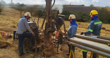 St George Mining workers next to drilling gear