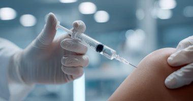 Knee joint injection with hyaluronic acid for osteoarthritis treatment. Medical procedure using syringe in sterile hospital environment. Professional orthopedic therapy for joint pain relief.